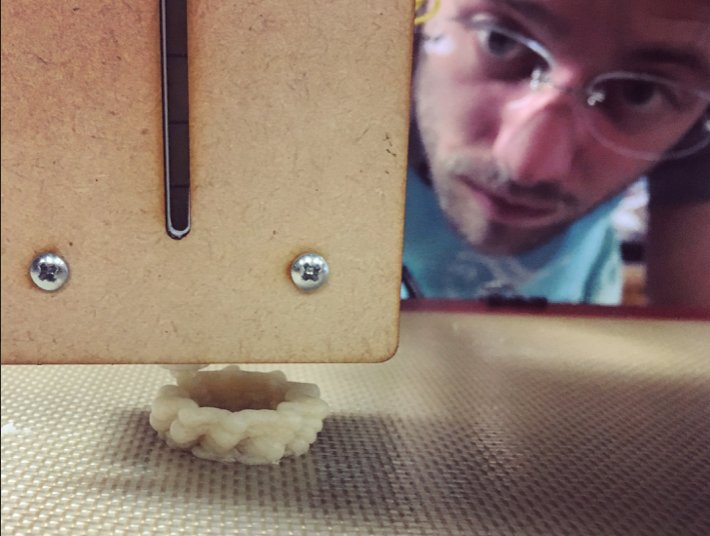 Isaac watching a pie crust extrude from the food printer