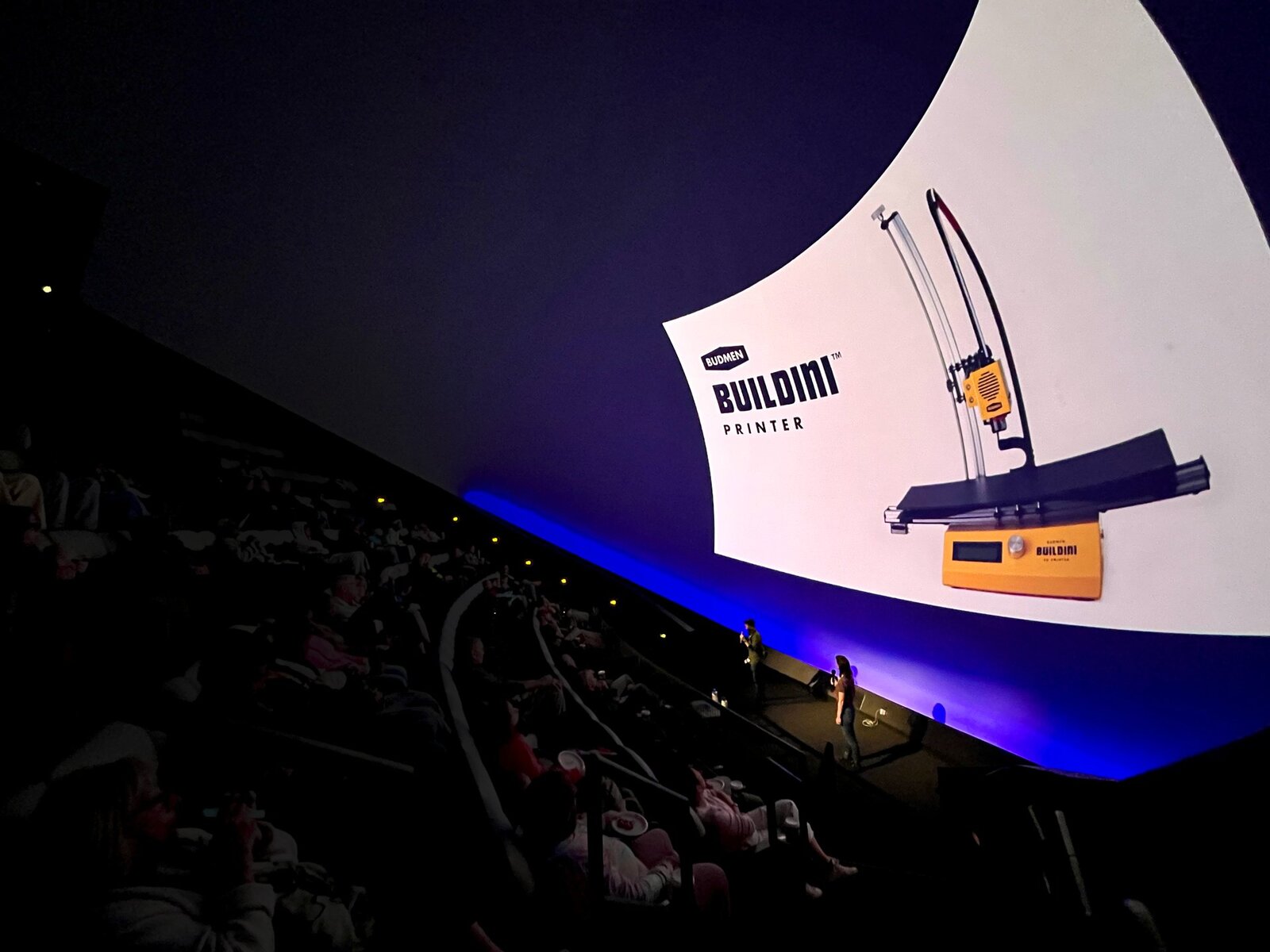 Stephanie and Isaac presenting the Buildini printer on the dome of a full planetarium